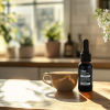 Zen All-Natural CBD Tincture Bottle Next to a Coffee Cup on a Sunlit Kitchen Counter