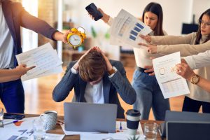 Group of business workers working together. Partners stressing one of them at the office